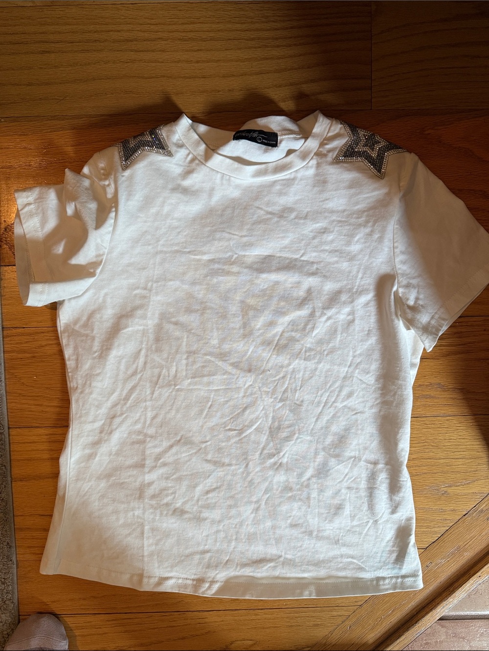 On twelfth White Short Sleeve Tee with Rhinestone Star Shoulder Detail- new l